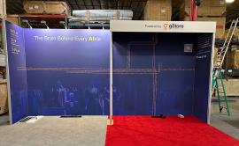 RENTAL: Custom Inline Design with 234" Wide x 118.75" High Gravitee Backwall, S44 Extrusion Return Frame Supporting Ceiling and Header Structure, (4) Monitor Mounts,(5) LED Arm Lights, 75" Monitor, (2) 43" Monitors, SEG Fabric Graphics, and Direct Print S